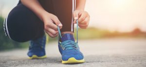 Close up shoes Female runner tying her shoes for a jogging exercise