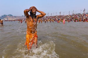 Kumbh Mela Hindu Festival, 2013, occurs every 12 years. Religious pilgrims taking holy bath in the Ganges River, Allahabad. Sadhus, holy men.