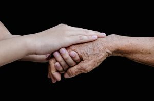 Encouragement old and young hands isolated on black background,include clipping path.