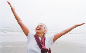 mature-woman-happy-beach
