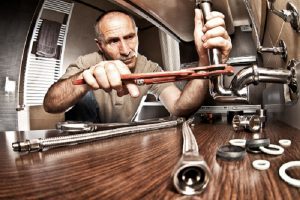 portrait of senior plumber at work