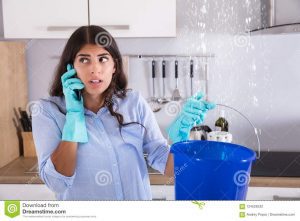 woman-calling-plumber-collecting-water-woman-calling-plumber-collecting-water-leaking-ceiling-using-bucket-124528332