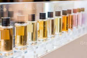 set of colorful perfume bottles in shop window.