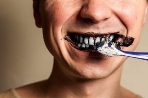 person-brushing-with-charcoal-toothpaste-1024x682-1