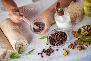 Young woman mixing ingredients for coffee facial mask for skin scrub treatment